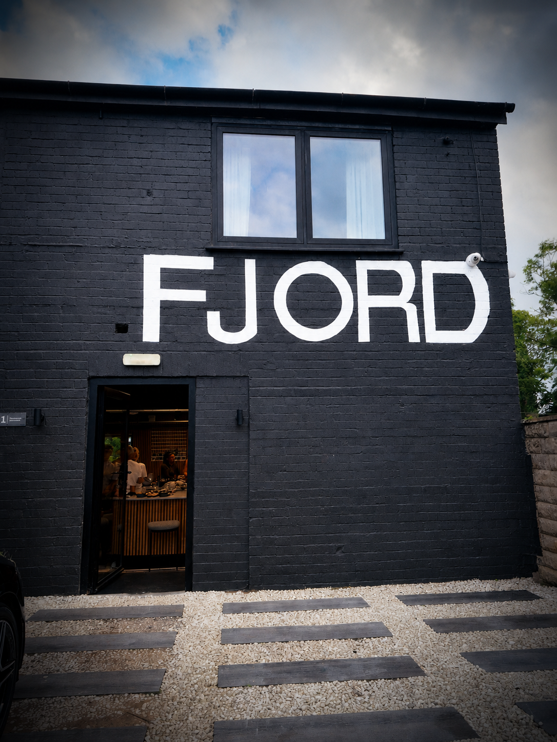 The Ruger Fjord black brick facade on Hartshead Street with large white FJORD lettering and an open doorway.