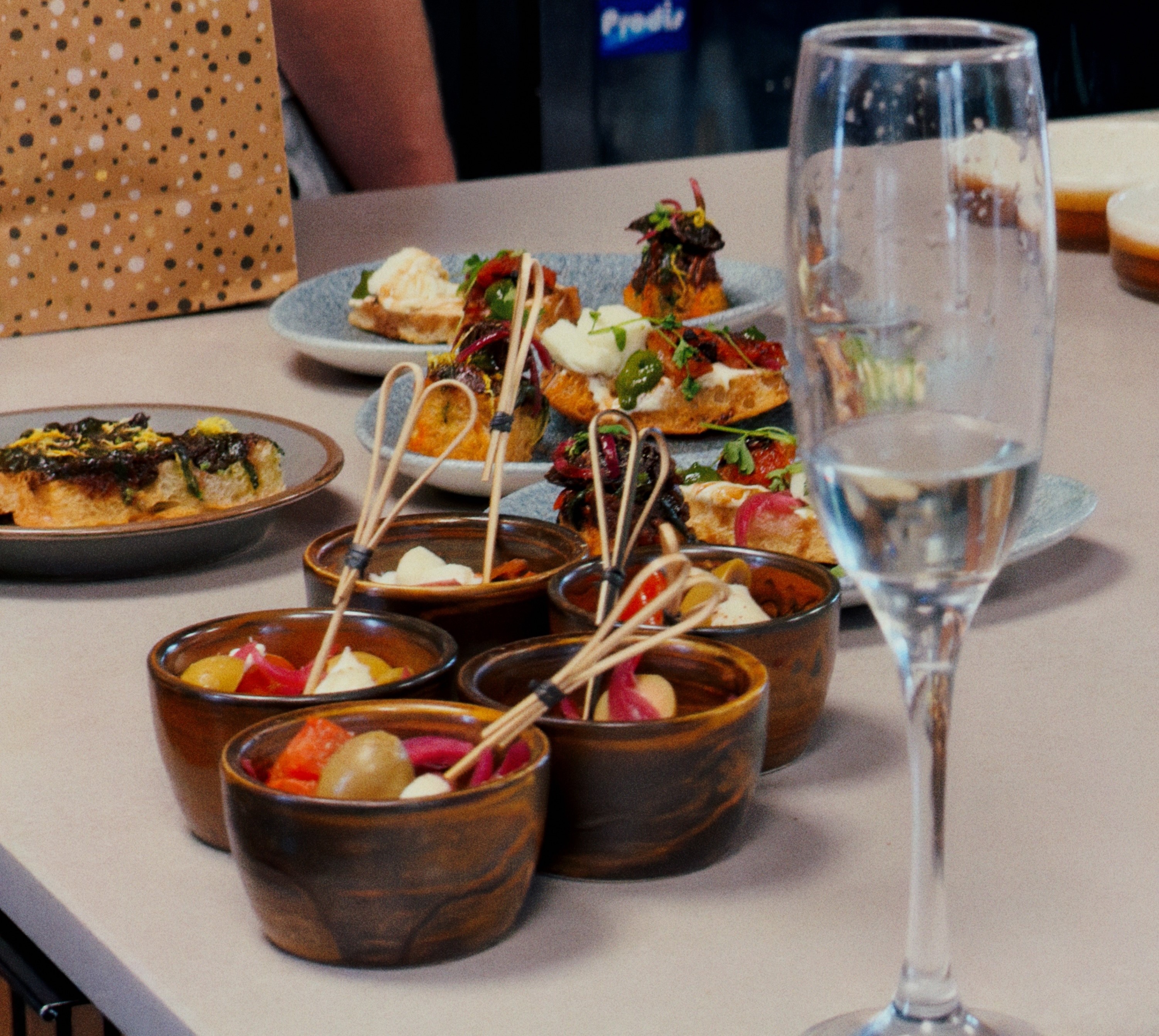 Ruger Fjord focaccia bites and dips served as a course of the table experience, alongside a glass of prosecco.
