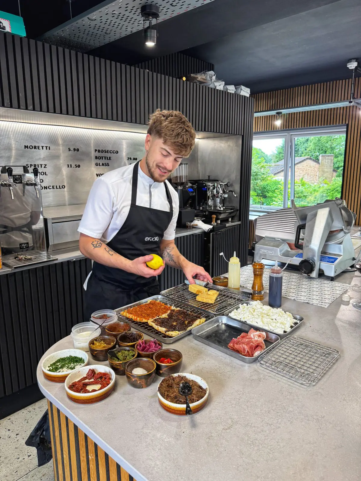 Kieran O'Reilly, chef and founder of Ruger Fjord, building focaccia sandwiches at the counter.
