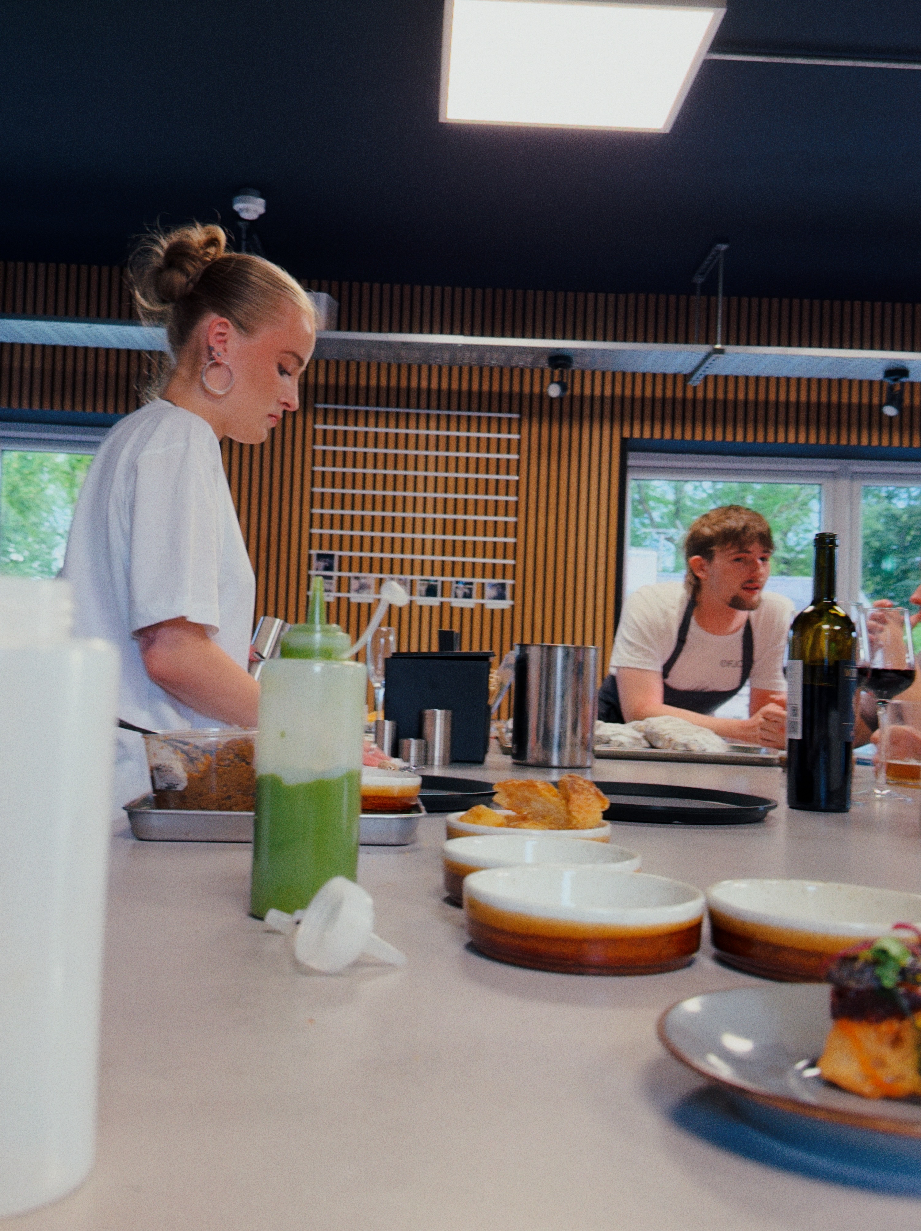 Two Fjord team members plating dishes for the Fjord table experience.